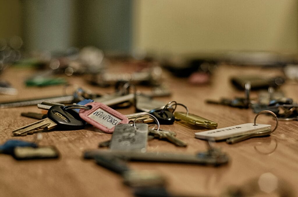 Englewood Locksmith, Macro shot of various metallic keys scattered on a wooden surface.